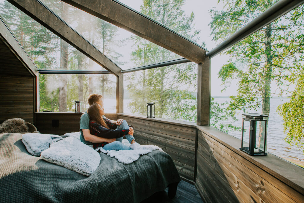 young couple relaxing in glass igloo